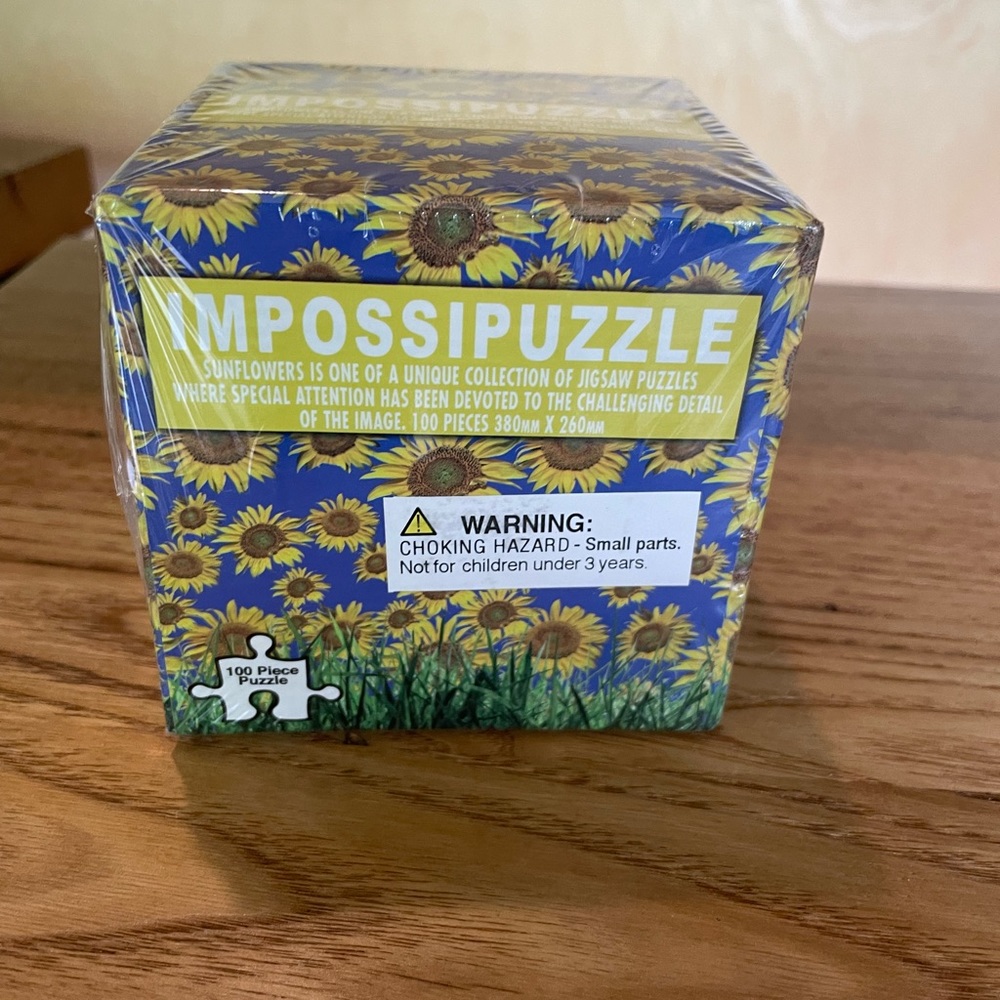 IMPOSSIPUZZLE. New, unopened 100 piece puzzle challenge! Sunflowers